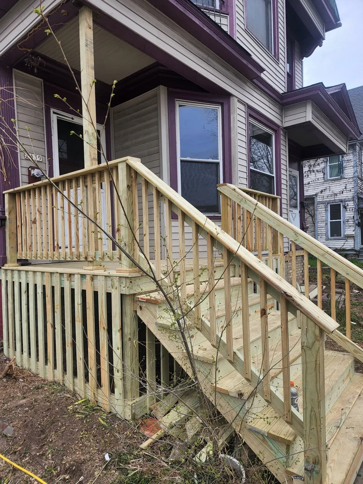 Wooden deck and railing on residential house front porch